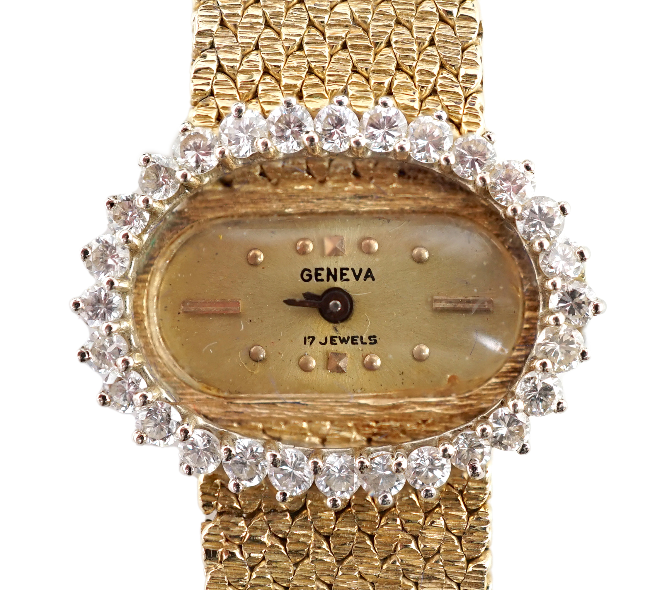 A lady's modern Swiss 14k gold and diamond set manual wind oval wrist watch, on integral 14k gold bracelet